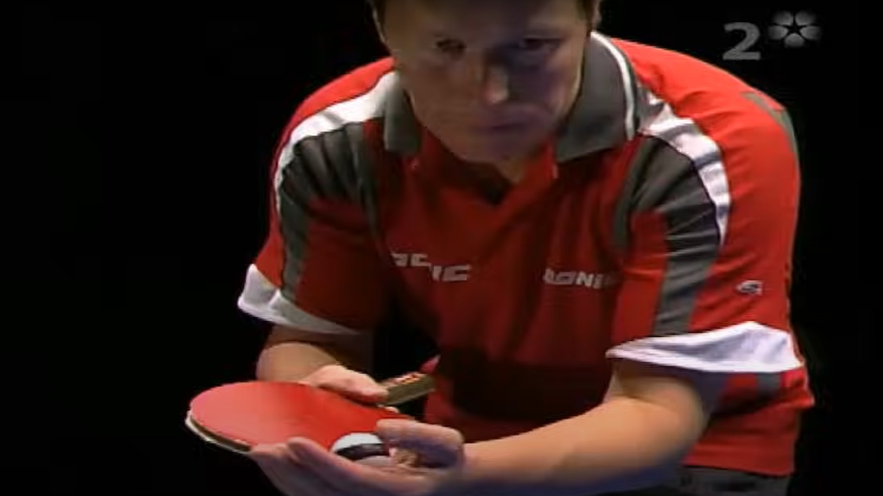 Jan-Ove Waldner in focused stance, preparing to serve with trademark finesse—capturing the quiet intensity and control that defined his table tennis mastery.